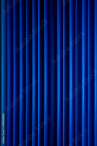 Stripes of blue light cut through the darkness creating an ideal background for textures and patterns.