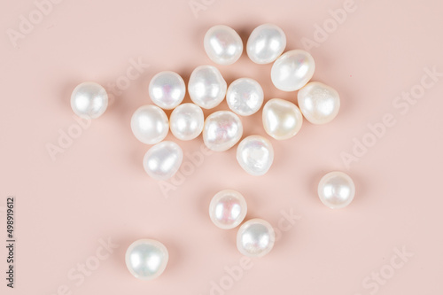 Canvas Print Natural freshwater round pearl beads on pink background. Top view