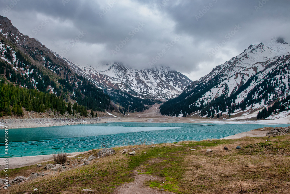 frozen lake in the mountains in early spring