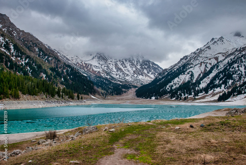 frozen lake in the mountains in early spring