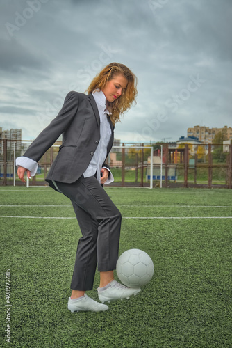 woman soccer player with ball on the field. ball dribbling, feint. photo