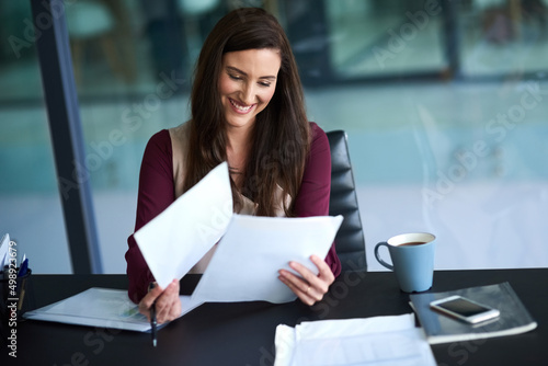 Knowing how to manage your workload is a valuable skill. Shot of a young businesswoman working on her admin.