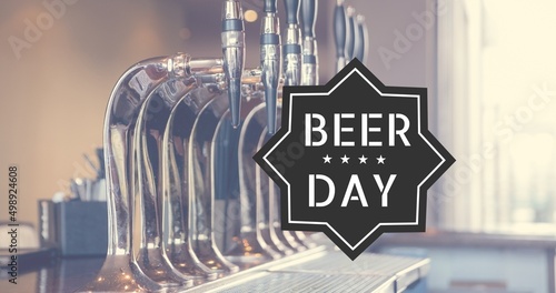 Composite image of beer taps and beer day text in bar, copy space