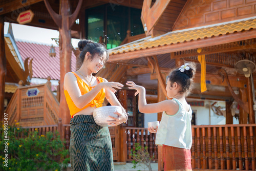 Girl in traditional Thai dress Songkran Festival in Thailand