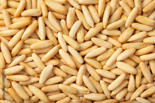 Food background of roasted European pine nuts, top view. photo