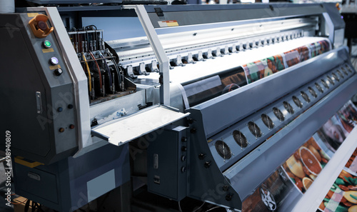 Industrial technician operating corrugated cardboard digital inkjet printer. Printing industry. photo