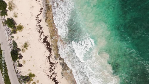 Bird's eye view drone shot of the beautiful coastline of Cozumel Mexico with incredible turquoise water crashing into the sandy beaches in 4k.  photo