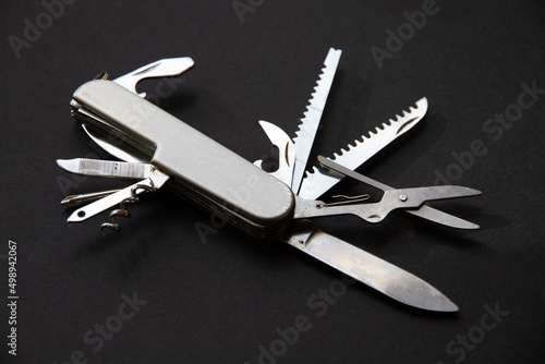Принти на полотні Metallic swiss knife isolated on black