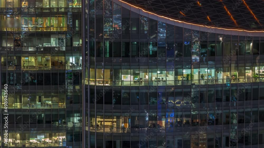 Big glowing windows in modern office and residential buildings timelapse at night Big glowing windows in modern office and residential buildings timelapse at night