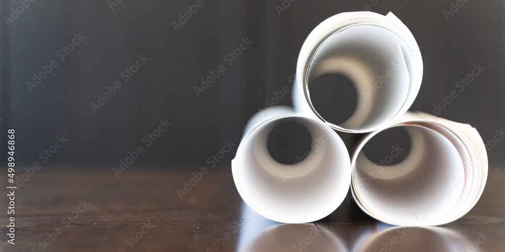 Pile of Building blueprints and plans on office table