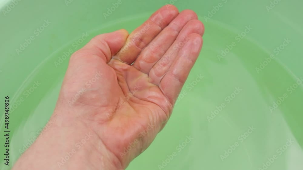 Wash hands in water in a basin. Hand hygiene. Wash the palms of your hands in water. Wash hands in water in a basin. Hand hygiene. Wash the palms of your hands in water.