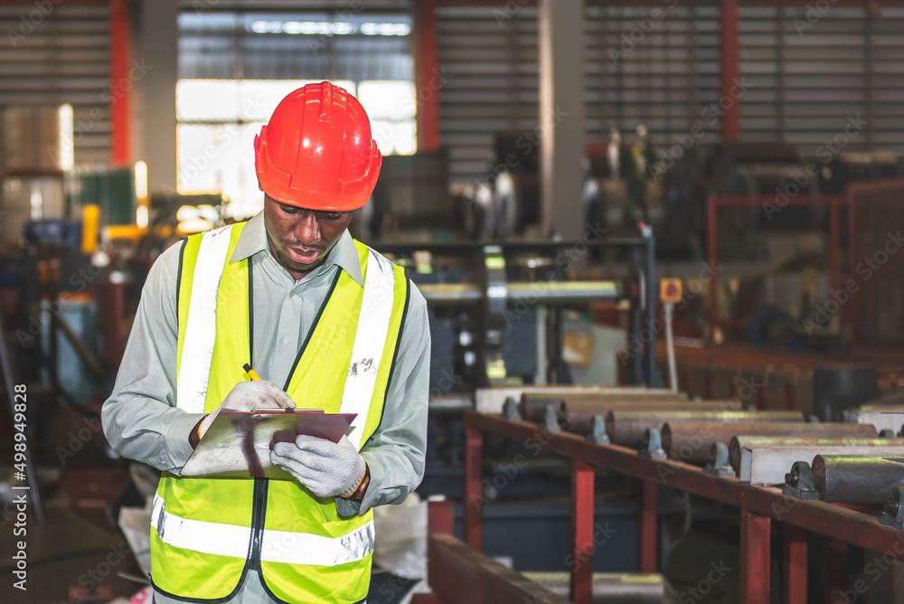 African American man workers, checking and writing material report for used in industrial production, to working people and industry concept. African American man workers, checking and writing material report for used in industrial production, to working people and industry concept.