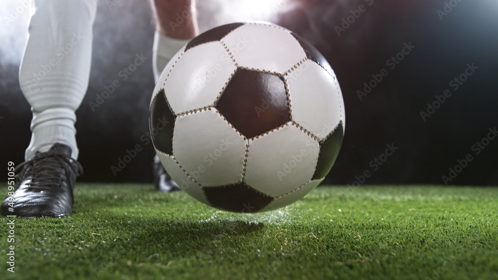 Fototapeta premium Close-up of Football Player Kicking Soccer Ball