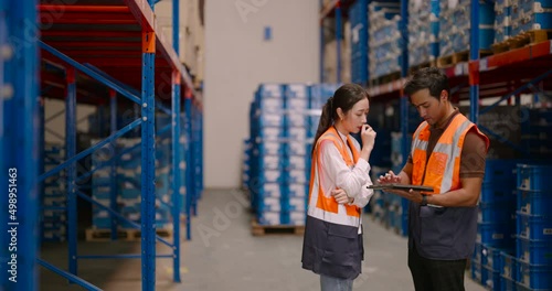 Warehouse workers discussing shipping schedule. Logistic and business export concept.