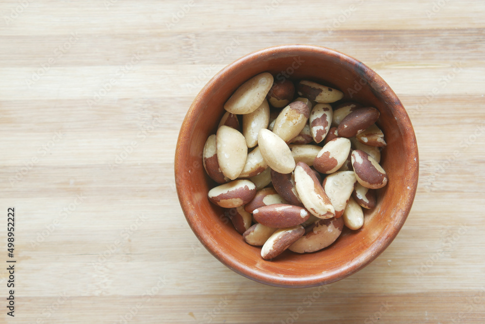 top view of Brazilian nut n a bowl on wooden background top view of Brazilian nut n a bowl on wooden background