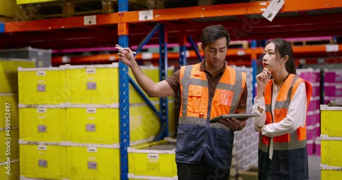 Warehouse workers discussing shipping schedule. Logistic and business export concept.