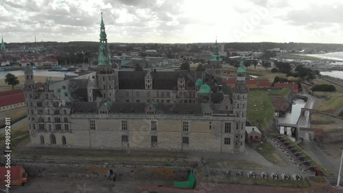 Cinematic 4K aerial drone orbit shot around Kronborg Slot Castle, one of UNESCO's World Heritage sites, Helsingør city and Marina in in Denmark photo