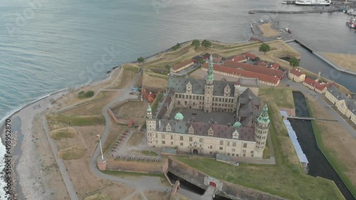 Cinematic 4K aerial drone bird's-eye 360 footage of Kronborg Slot Castle, one of UNESCO's World Heritage sites, Helsingør city and Marina in in Denmark photo