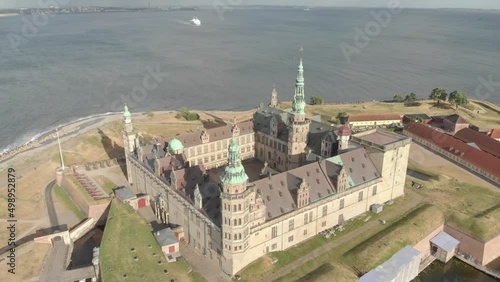 Cinematic 4K aerial drone bird's-eye footage of Kronborg Slot Castle, one of UNESCO's World Heritage sites, Helsingør city and Marina in in Denmark photo