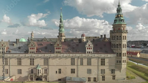 Cinematic 4K aerial drone trucking reveal shot of Kronborg Slot Castle, one of UNESCO's World Heritage sites, Helsingør city and Marina in in Denmark photo