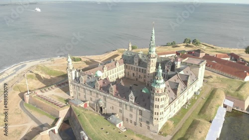 Cinematic 4K aerial drone footage of the walls and canons of Kronborg Slot Castle, one of UNESCO's World Heritage sites, Helsingør city and Marina in in Denmark photo