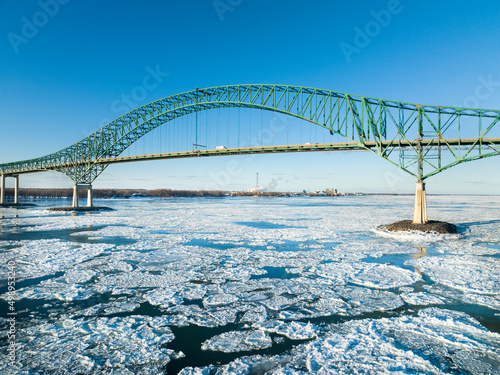 Laviolette Bridge, during winter, crossing the St. Lawrence River and ice floe in Trois-Rivieres, Quebec, Canada photo