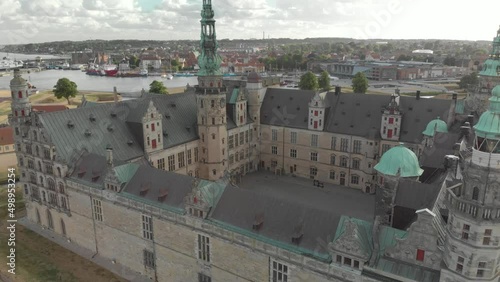 Cinematic 4K aerial drone close-up orbit shot of Kronborg Slot Castle, one of UNESCO's World Heritage sites, Helsingør city and Marina in in Denmark photo