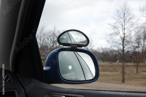 Road and cars in side mirror of car