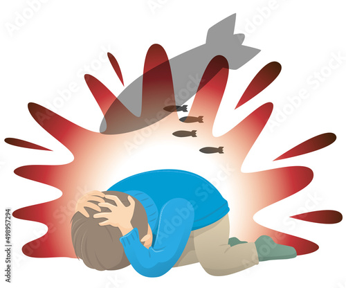 A person who is frightened by the bombing and crouches