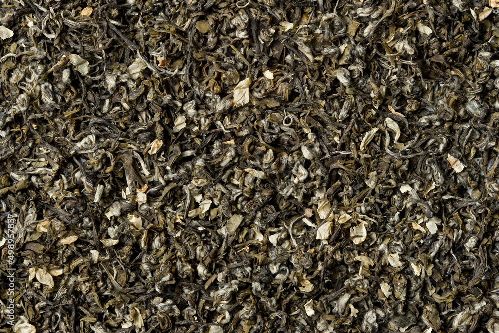 Green tea with jasmine petals on white background. Top view. Close up. High resolution Green tea with jasmine petals on white background. Top view. Close up. High resolution