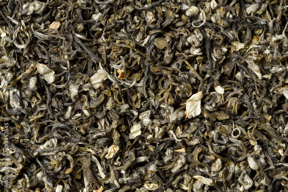 Green tea with jasmine petals on white background. Top view. Close up. High resolution Green tea with jasmine petals on white background. Top view. Close up. High resolution