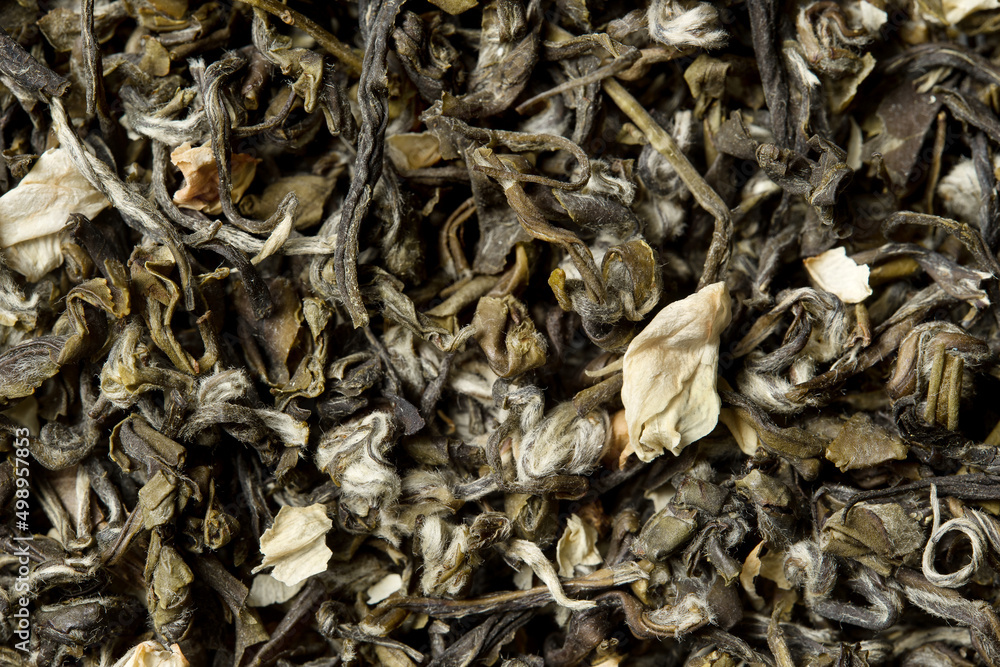Green tea with jasmine petals on white background. Top view. Close up. High resolution Green tea with jasmine petals on white background. Top view. Close up. High resolution