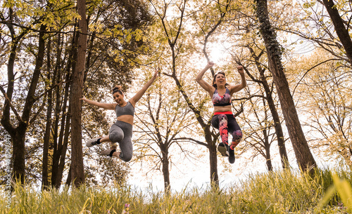 beautiful middle aged women jumping happy through the forest