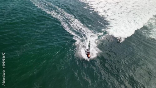 SURFERS DUCKDIVING IN EL TUNCO BEACH IN SAN SALVADOR, EL SALVADOR photo