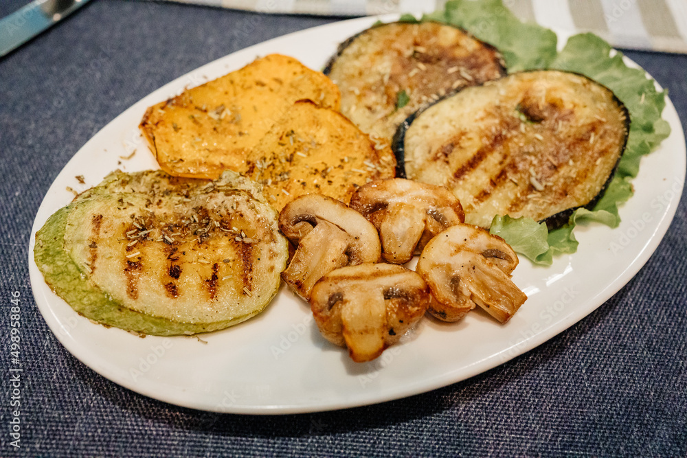 grilled mushrooms, eggplant, zucchini and bell peppers on a plate. grilled mushrooms, eggplant, zucchini and bell peppers on a plate.