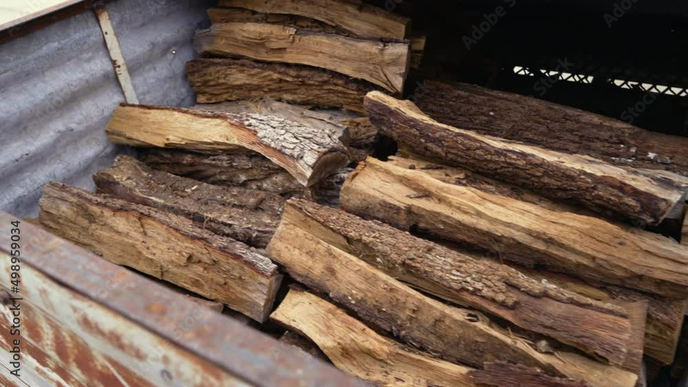 Piles of firewood stacked high in shed, 4K Piles of firewood stacked high in shed, 4K