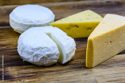 Various types of cheese on a wooden background
