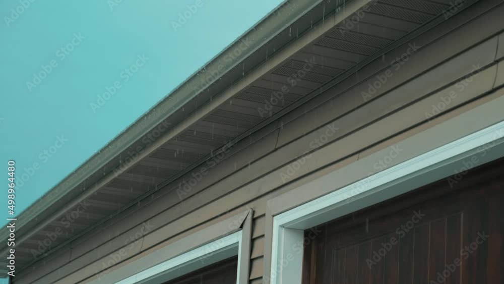 Water dripping from the gutter of a house after a huge thunderstorm Water dripping from the gutter of a house after a huge thunderstorm