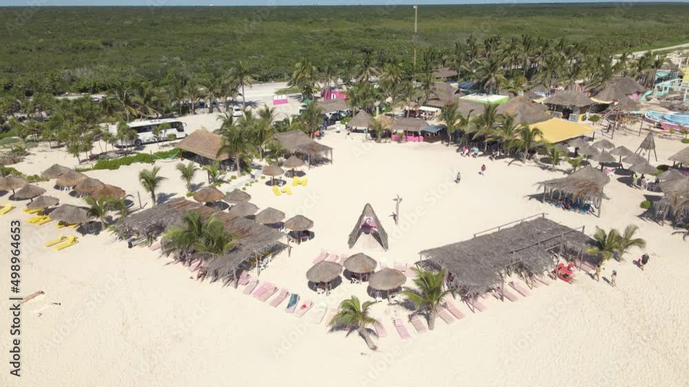 Downward panning drone shot of a resort on the beach with many areas to sit and umbrellas to get out of the hot sun located in Cozumel, Mexico shot in 4k. Downward panning drone shot of a resort on the beach with many areas to sit and umbrellas to get out of the hot sun located in Cozumel, Mexico shot in 4k.
