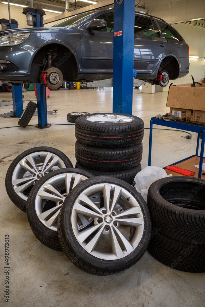 Wheels with summer tires are ready to be mounted in a workshop