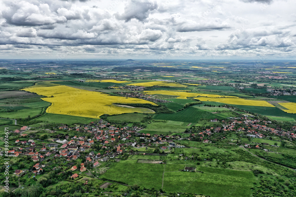 Aerial panorama of Bohemian countryside with rape fields