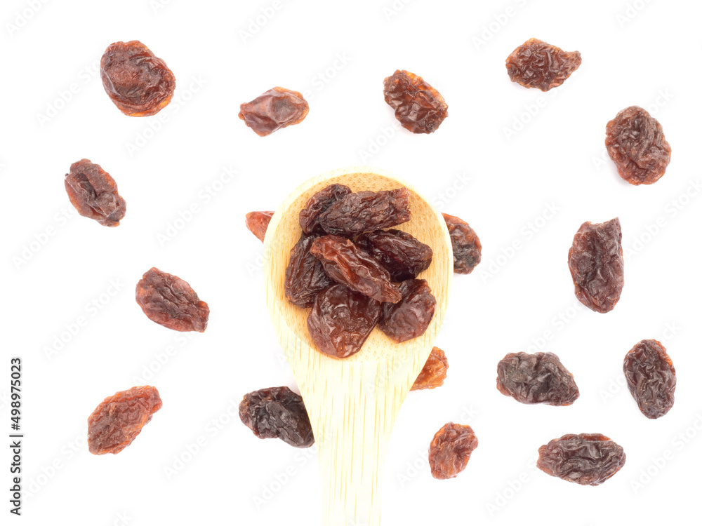 Raisin in spoon and bunch isolated on white background. Macro. Vegetarian concept Raisin in spoon and bunch isolated on white background. Macro. Vegetarian concept