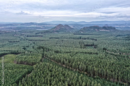 Large plain with woods and forests with mountains in background