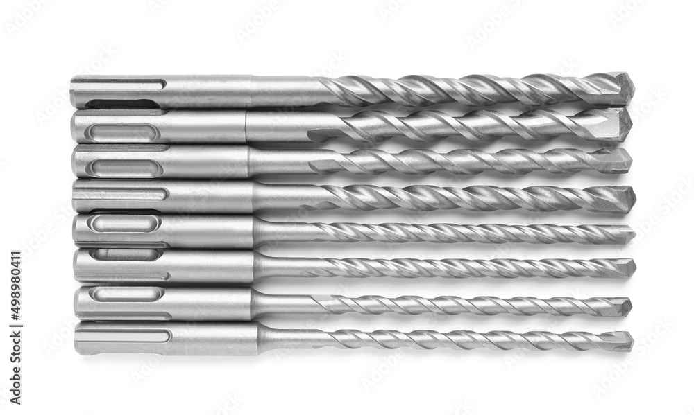 Many twist drill bits isolated on white, top view. Carpenter's tools Many twist drill bits isolated on white, top view. Carpenter's tools