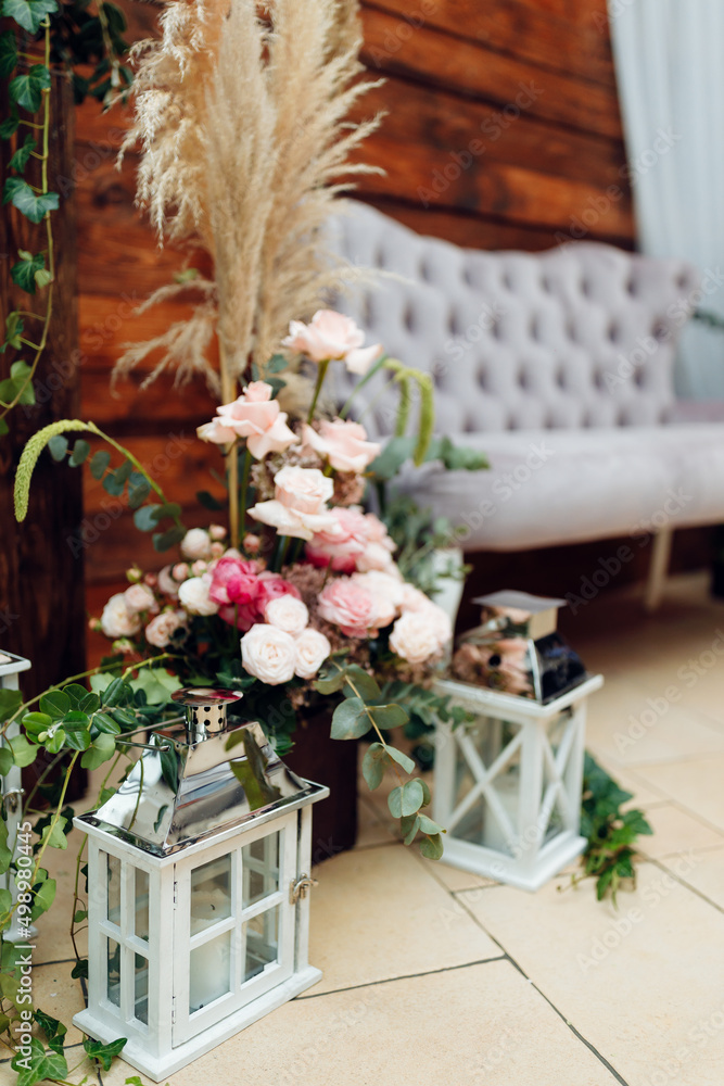 wooden photo zone decorated with natural flowers