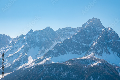 Beautiful majestic kronplatz mountain range against clear blue sky in winter © Aerial Film Studio