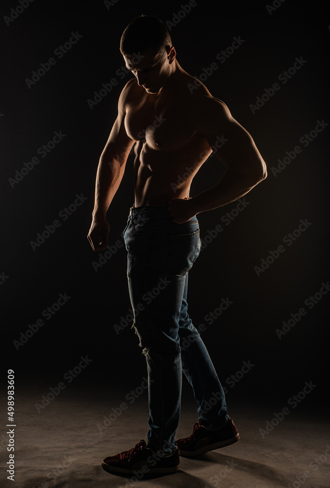 Silhouette of topless guy posing and flexing
