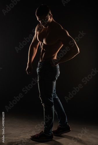 Silhouette of topless guy posing and flexing © qunica.com