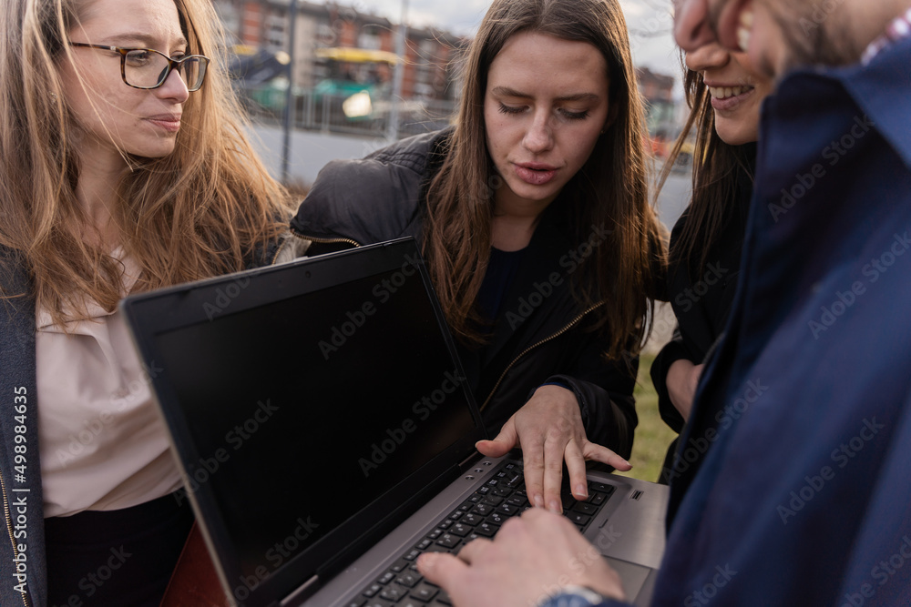 Looking at the lap top and discussing the ideas Looking at the lap top and discussing the ideas