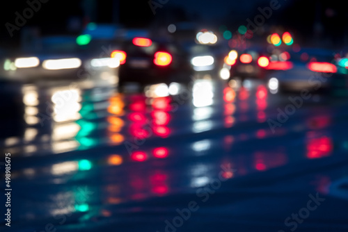car traffic in the evening on wet road. blurred motion.